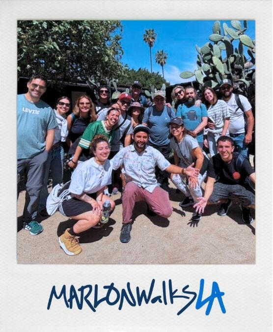 Selfie with Kobe Bryant Mural at Grand Central Market A happy group of travelers experiencing the real LA with MarlonWalksLA. Local guide Marlon stands in the center of a Spanish and English speaking group at Placita Olvera and inside of Avila Adobe's garden, a sunlit outdoor setting with cactus and palm tree